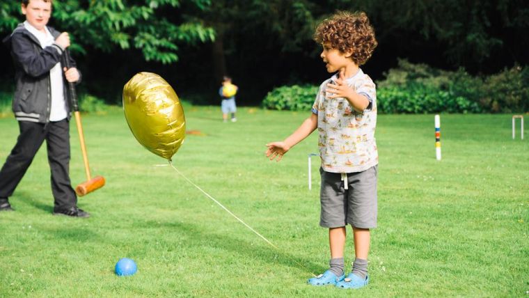 Maintaining a Silver Award is something worth celebrating, but we are still going for gold. (Photo of a child chasing a gold balloon).