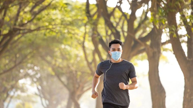 A jogger wearing a mask