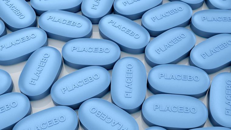 The history of open-label placebos can be traced back to at least 1965. (Image of blue pills with placebo written on them)