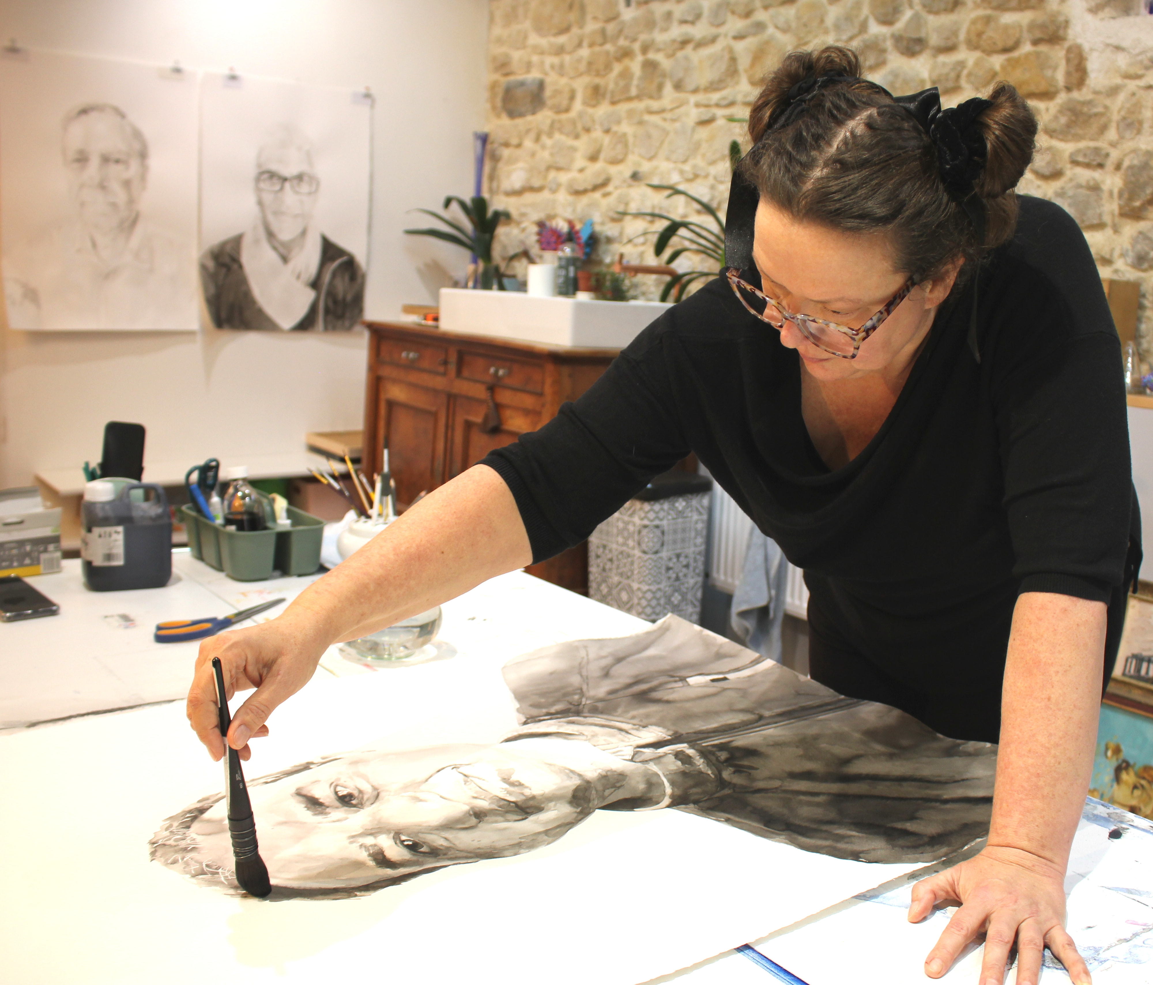 Artist Tanya Poole painting in her studio 