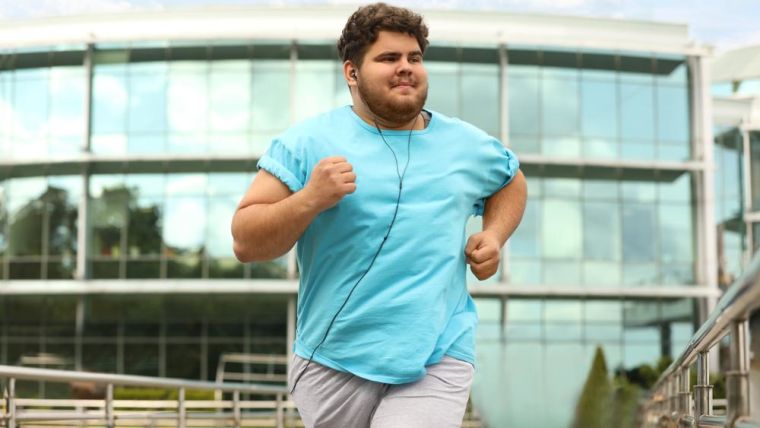 A young man running outdoors.