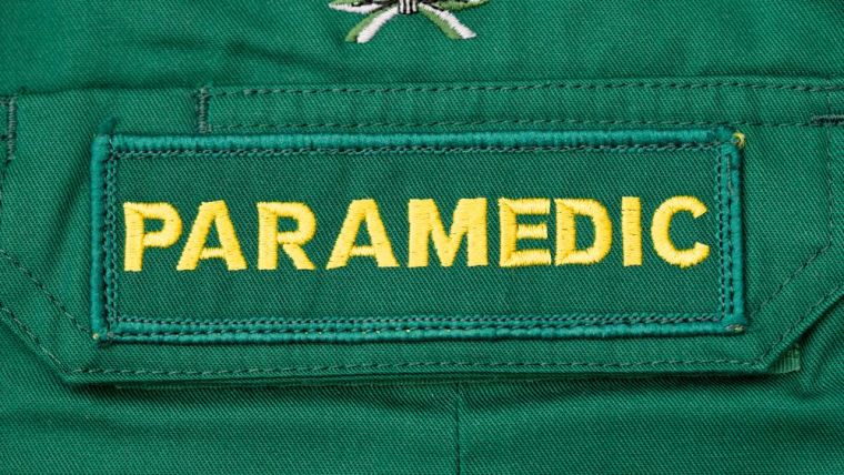 A woven badge that says "paramedic" on a uniform.