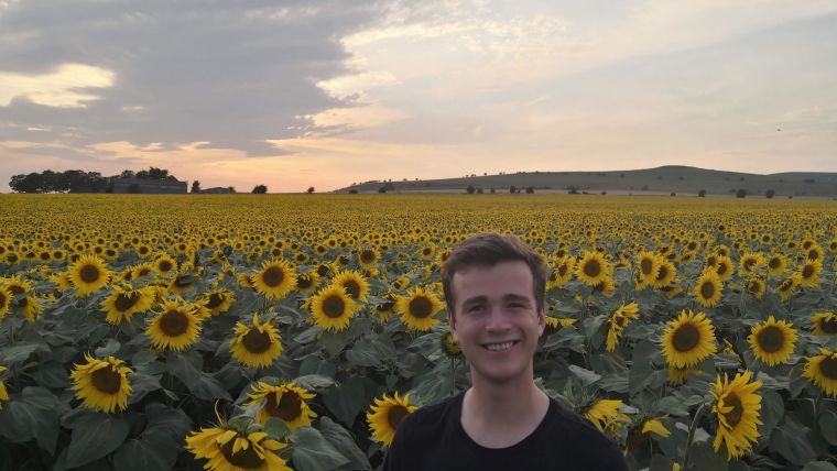 FHS student, Harrison France, in field of sunflowers
