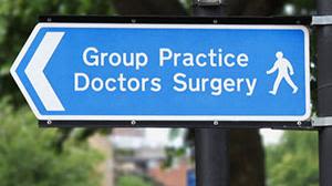 A blue sign for a GP surgery