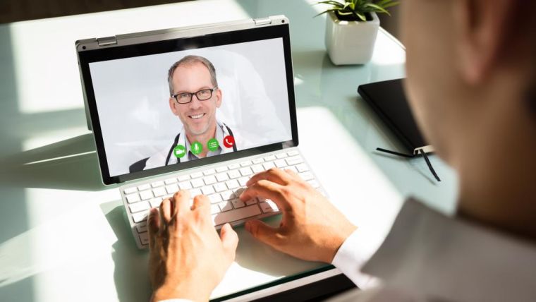 Man doing video conference with doctor on a laptop